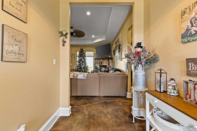 hallway with a raised ceiling