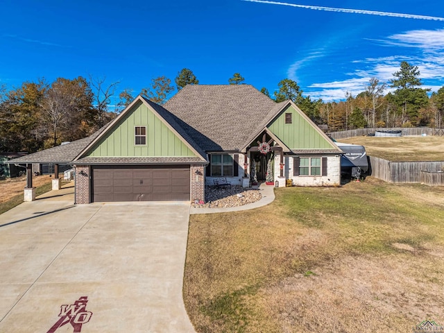 view of front of home with a front yard and a garage