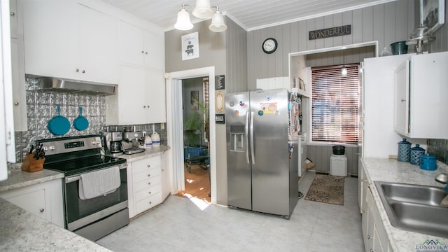 kitchen with appliances with stainless steel finishes, white cabinets, wall chimney range hood, decorative backsplash, and sink