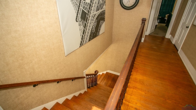 staircase with hardwood / wood-style flooring