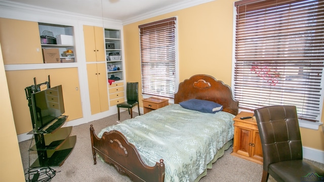 bedroom with crown molding and light colored carpet