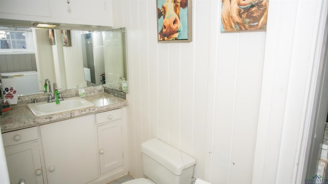 bathroom featuring toilet and vanity