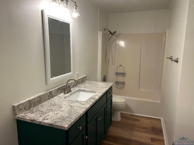 full bathroom with toilet, wood-type flooring, vanity, and  shower combination