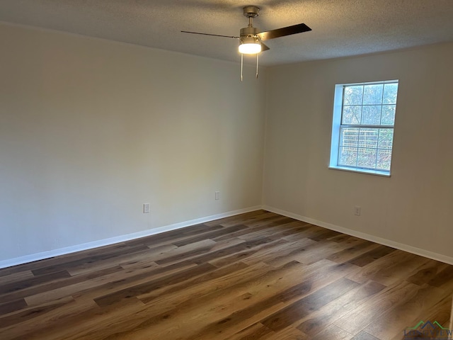 unfurnished room with ceiling fan, a textured ceiling, and dark hardwood / wood-style floors