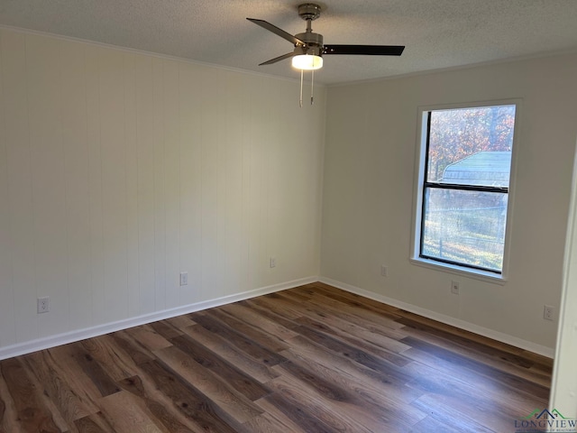 unfurnished room with a textured ceiling, ceiling fan, and dark wood-type flooring