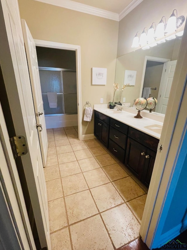 1928 Eastwood Dr, Henderson, TX 75652 - full bath featuring crown molding, double vanity, baseboards, tile patterned flooring, and bath / shower combo with glass door
