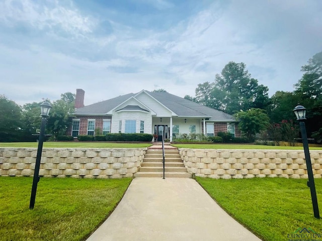 1928 Eastwood Dr, Henderson, TX 75652 - view of front facade with a front lawn and a chimney