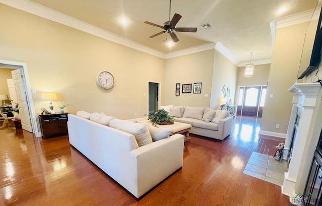 1928 Eastwood Dr, Henderson, TX 75652 - living room featuring a fireplace with flush hearth, ceiling fan, wood finished floors, baseboards, and crown molding