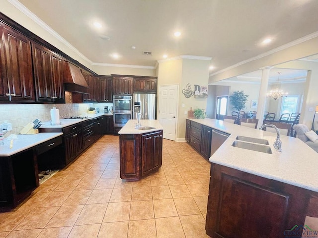 1928 Eastwood Dr, Henderson, TX 75652 - kitchen with custom range hood, stainless steel appliances, a kitchen island with sink, a sink, and crown molding