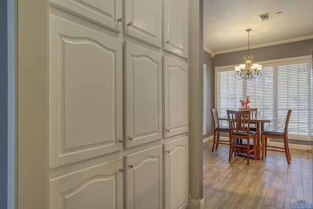 36 Briarwood Cir, Texarkana, TX 75503 - dining room featuring baseboards, plenty of natural light, a chandelier, crown molding, and light wood-type flooring