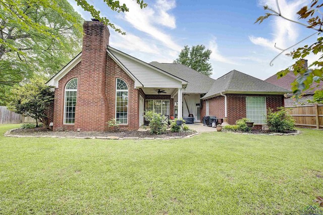 36 Briarwood Cir, Texarkana, TX 75503 - view of front facade with a ceiling fan, brick siding, a chimney, and roof with shingles