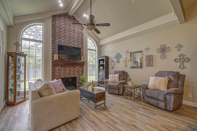 36 Briarwood Cir, Texarkana, TX 75503 - living area featuring ceiling fan, beam ceiling, a brick fireplace, wood finished floors, and high vaulted ceiling