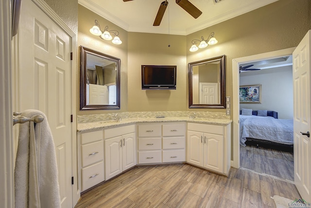 36 Briarwood Cir, Texarkana, TX 75503 - bathroom with a ceiling fan, ornamental molding, wood finished floors, double vanity, and ensuite bathroom