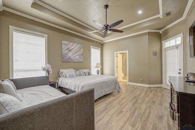 36 Briarwood Cir, Texarkana, TX 75503 - bedroom featuring a raised ceiling, crown molding, light wood-style floors, baseboards, and connected bathroom