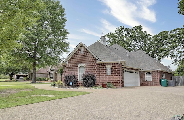 36 Briarwood Cir, Texarkana, TX 75503 - view of front of home with brick siding, an attached garage, central air condition unit, asphalt driveway, and a shingled roof