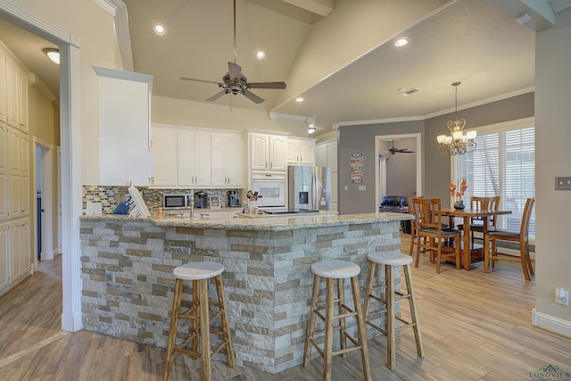 36 Briarwood Cir, Texarkana, TX 75503 - kitchen with ceiling fan, stainless steel appliances, a peninsula, decorative backsplash, and light wood-style floors