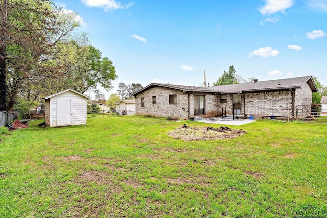 back of house with a storage unit, a patio area, and a yard