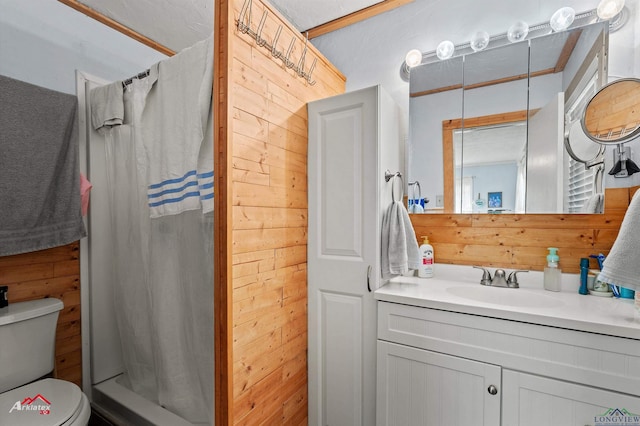 bathroom with vanity, curtained shower, wood walls, and toilet