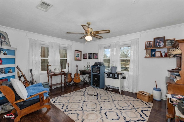 office with dark wood-type flooring, ceiling fan, and ornamental molding