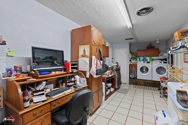 clothes washing area featuring independent washer and dryer, a textured ceiling, and light tile patterned flooring