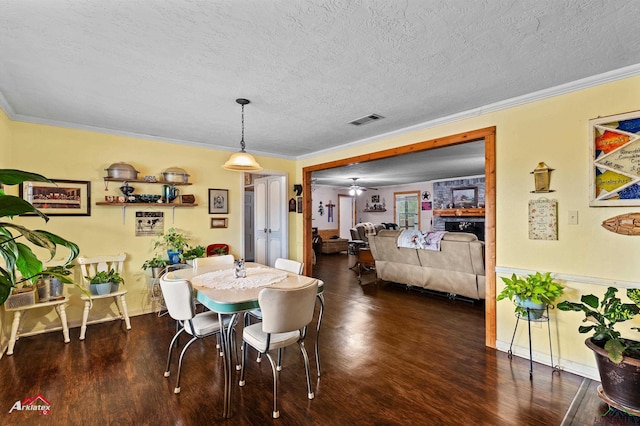 dining space with ornamental molding and dark hardwood / wood-style floors