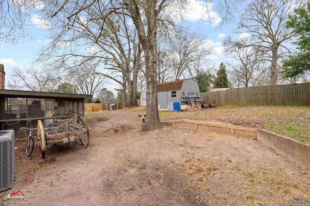 view of yard featuring central AC and a shed