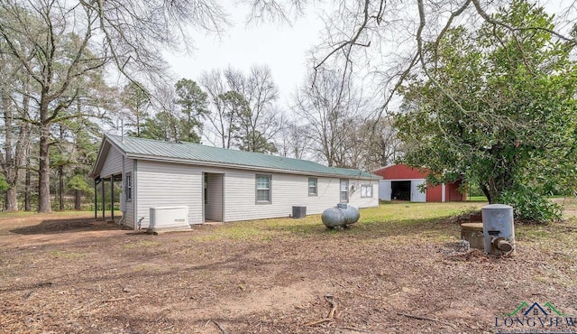 rear view of property featuring an outdoor structure