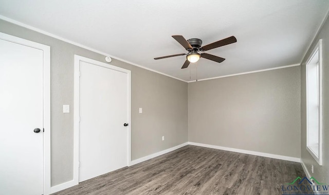 unfurnished room with crown molding, ceiling fan, and dark wood-type flooring