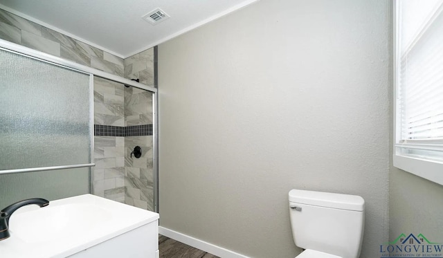 bathroom featuring hardwood / wood-style flooring, toilet, and a shower with door