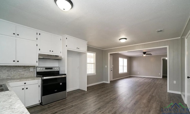 kitchen featuring a textured ceiling, white cabinetry, stainless steel range with electric stovetop, and ornamental molding