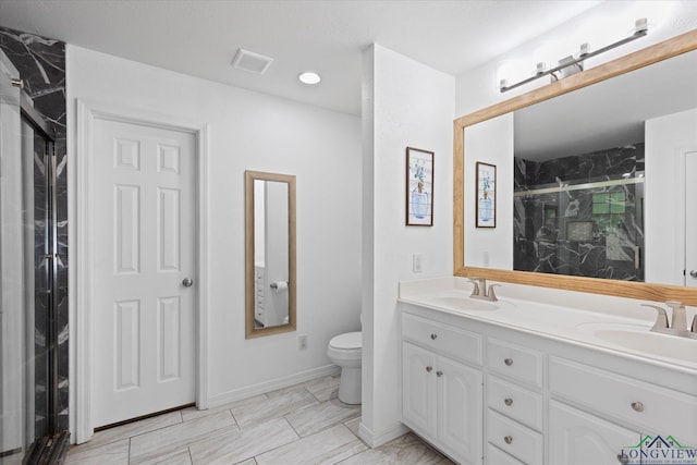 908 Victoria Dr, Longview, TX 75604 - full bathroom featuring double vanity, a sink, a marble finish shower, and toilet