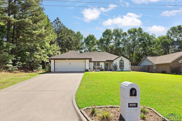 908 Victoria Dr, Longview, TX 75604 - ranch-style house with an attached garage, a front lawn, fence, and concrete driveway