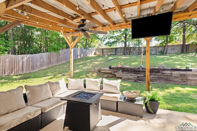 908 Victoria Dr, Longview, TX 75604 - view of patio with ceiling fan, a fenced backyard, and an outdoor living space with a fire pit