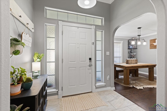 908 Victoria Dr, Longview, TX 75604 - foyer with baseboards, arched walkways, and ornamental molding