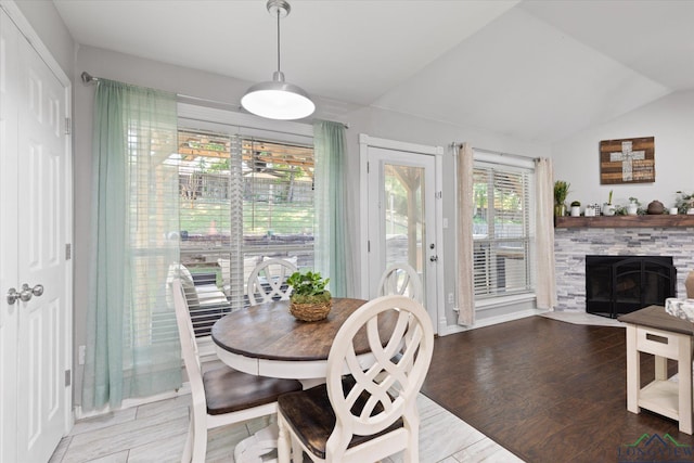 908 Victoria Dr, Longview, TX 75604 - dining space featuring ceiling fan, vaulted ceiling, wood finished floors, and a fireplace