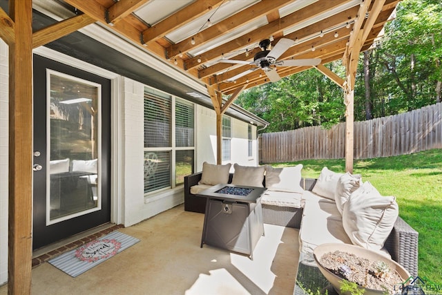 908 Victoria Dr, Longview, TX 75604 - view of patio / terrace featuring fence, an outdoor living space with a fire pit, and ceiling fan