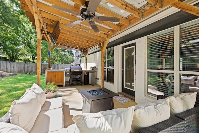 908 Victoria Dr, Longview, TX 75604 - view of patio / terrace with a fenced backyard, an outdoor living space with a fire pit, and a ceiling fan