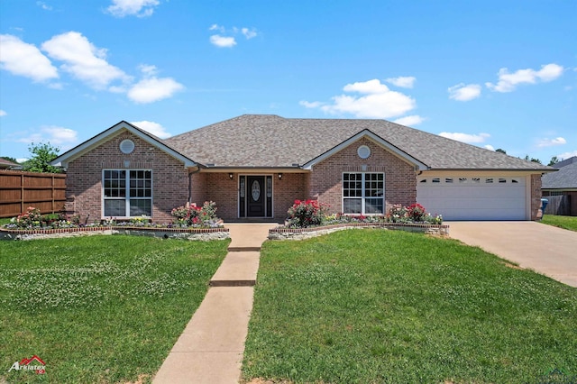 single story home with driveway, fence, brick siding, a garage, and a front yard