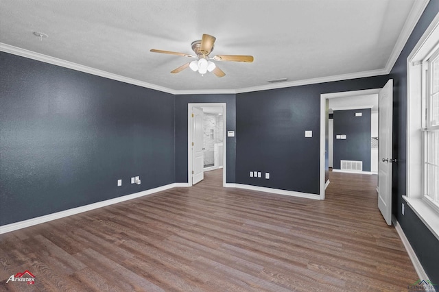 spare room featuring ceiling fan, baseboards, wood finished floors, and visible vents