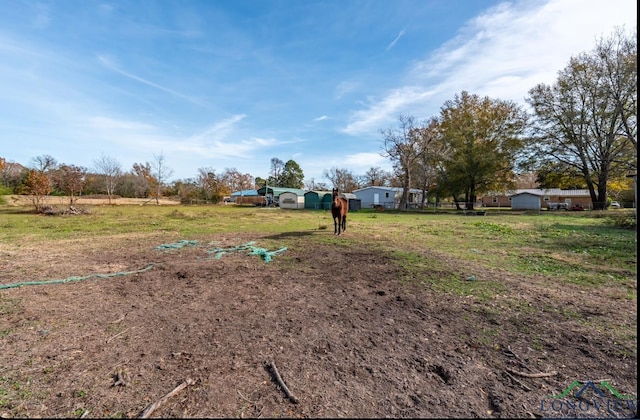 view of yard with a rural view