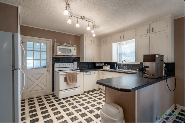 kitchen featuring kitchen peninsula, sink, white cabinets, and white appliances