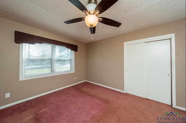 unfurnished bedroom featuring ceiling fan, a closet, carpet, and a textured ceiling