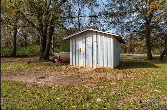 view of outbuilding with a yard