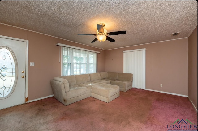 unfurnished living room with carpet, a textured ceiling, and ceiling fan