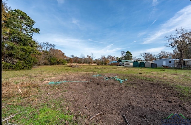 view of yard with a rural view