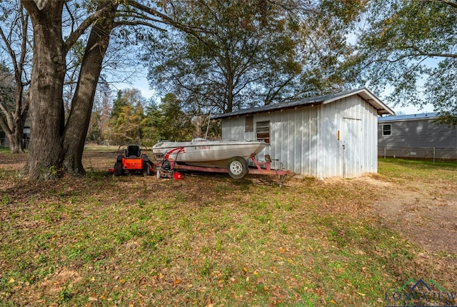 view of outbuilding featuring a yard