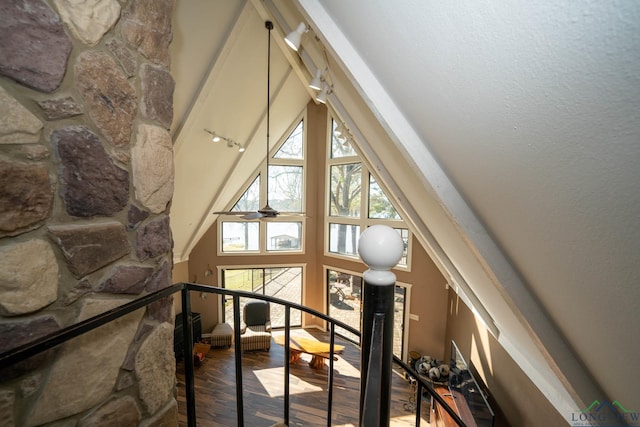 stairway with hardwood / wood-style floors and ceiling fan