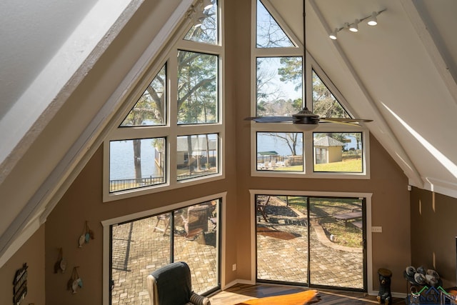 interior space featuring ceiling fan, plenty of natural light, and lofted ceiling