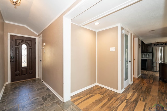 entryway featuring crown molding and lofted ceiling