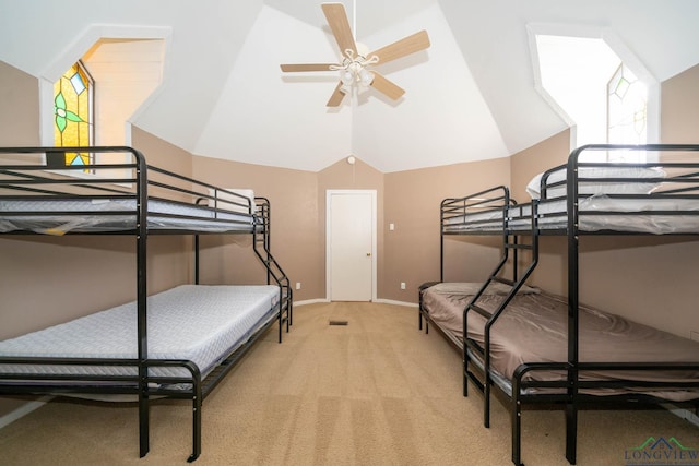 bedroom featuring ceiling fan, light carpet, and vaulted ceiling